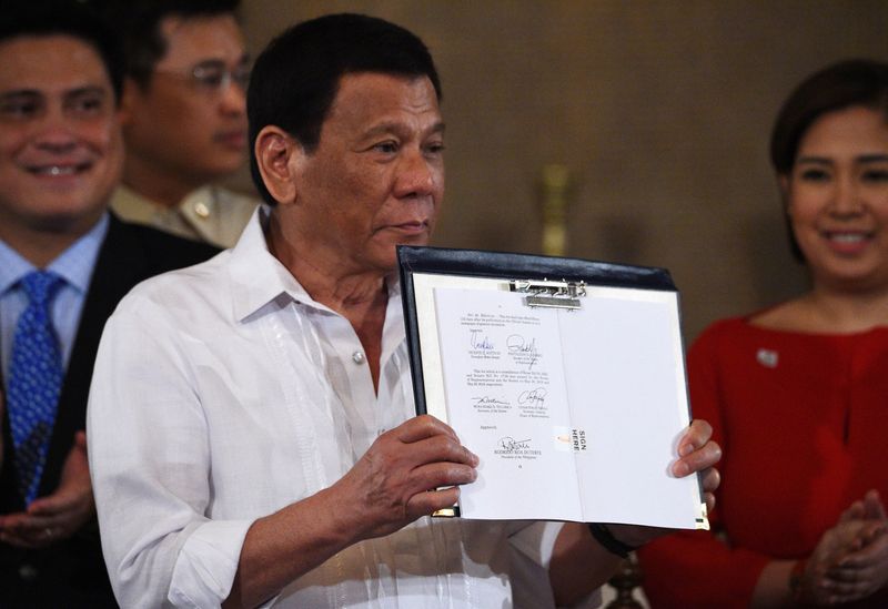 President Rodrigo Duterte presents signed Identification System Act.  Accessed Nov 06, 2018. Source: Ted Aljibe/AFP/Getty Images.